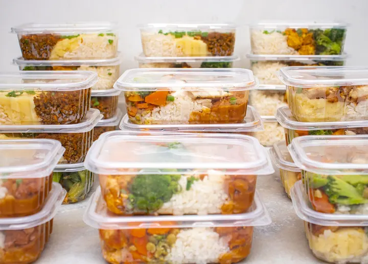 A week of lidded meal prep containers stacked and ready for the fridge